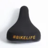 Selle BIKELIFE Noire Logo Orange -Magasin De Vélos selle bikelife noire logo orange